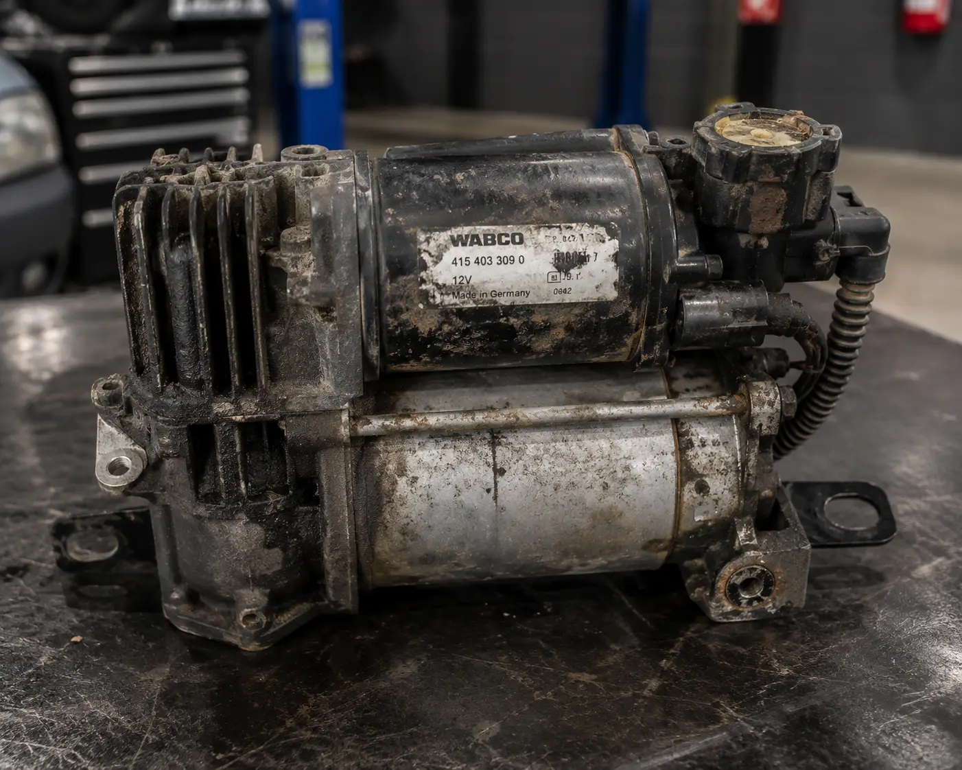Worn air suspension compressor repaired for a luxury SUV during air suspension repair